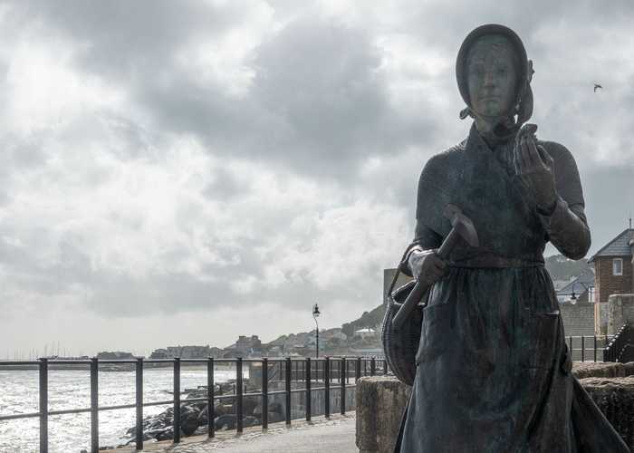 Mary Anning fossil hunting statue Lyme Regis
